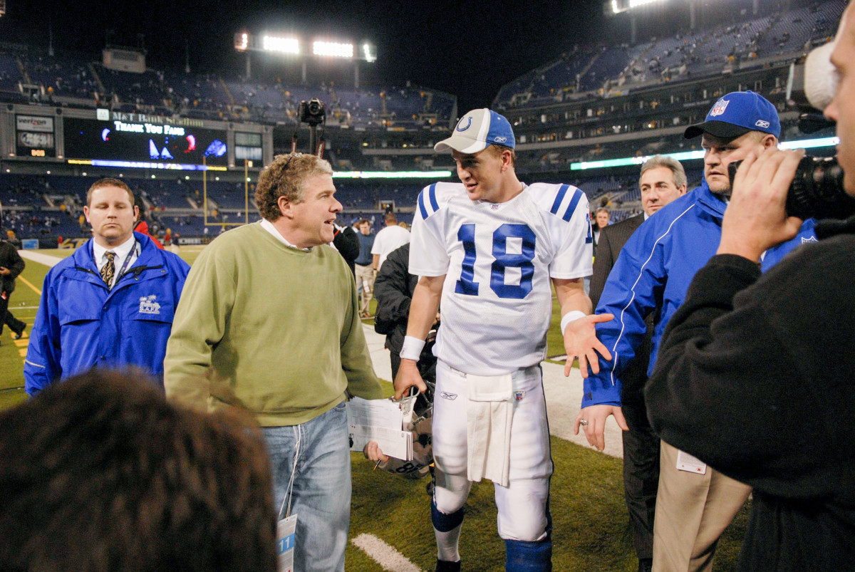Peter King walks alongside Peyton Manning